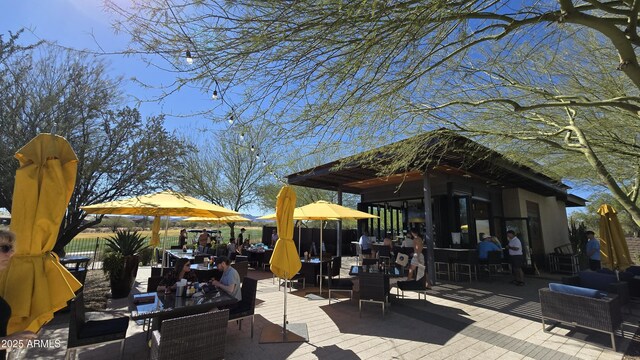 view of patio featuring outdoor dining area and fence