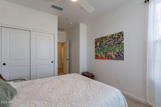 bedroom with ceiling fan, carpet, and a closet