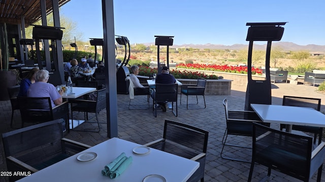 view of patio featuring outdoor dining area and a mountain view