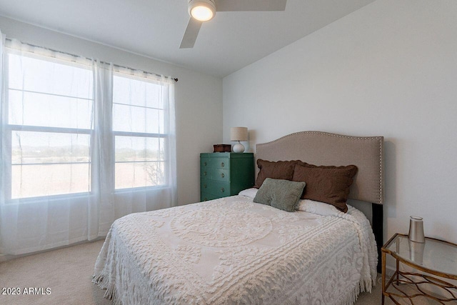 carpeted bedroom with a ceiling fan and lofted ceiling