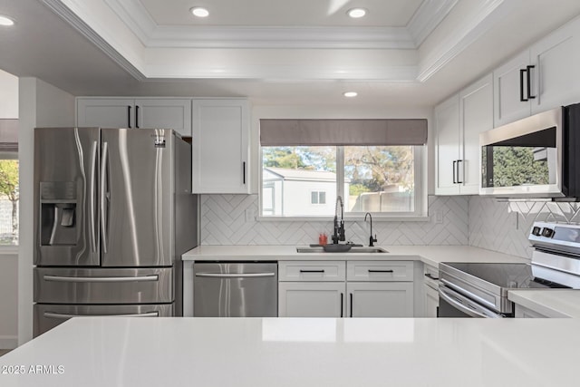 kitchen with white cabinetry, sink, decorative backsplash, and stainless steel appliances