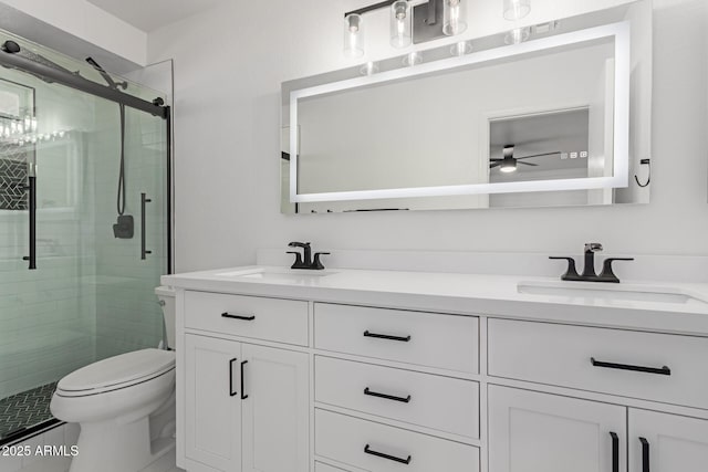 bathroom featuring vanity, toilet, and walk in shower