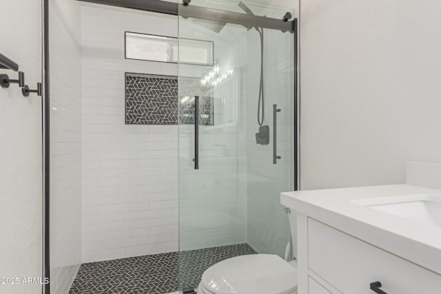 bathroom with walk in shower, vanity, and toilet