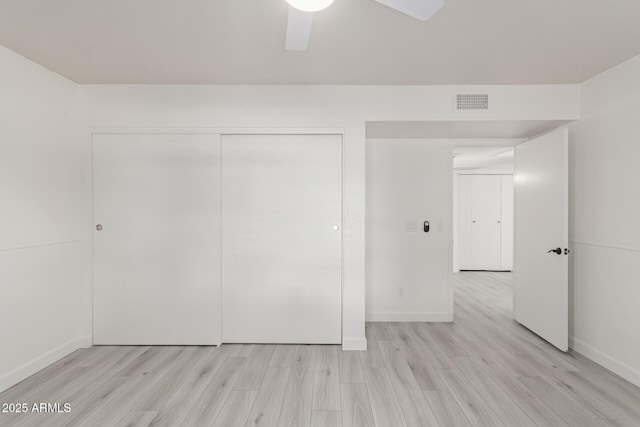 unfurnished bedroom with a closet, ceiling fan, and light hardwood / wood-style floors