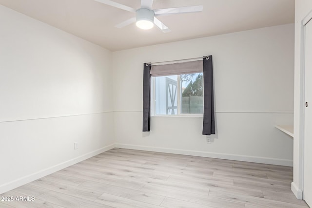 spare room with ceiling fan and light wood-type flooring