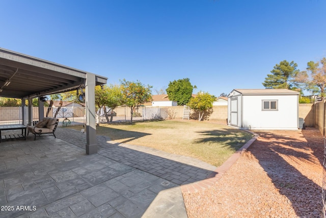 view of yard featuring a shed and a patio area