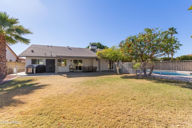 rear view of property featuring central AC, a fenced in pool, a patio, and a lawn