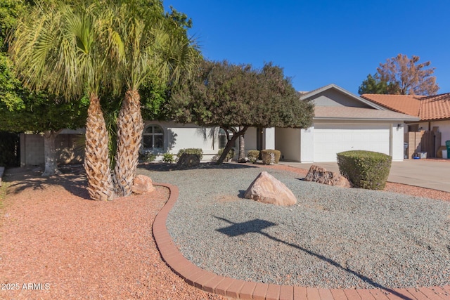 view of property hidden behind natural elements featuring a garage