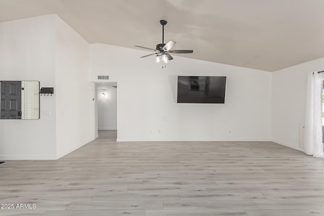 unfurnished living room with ceiling fan and vaulted ceiling