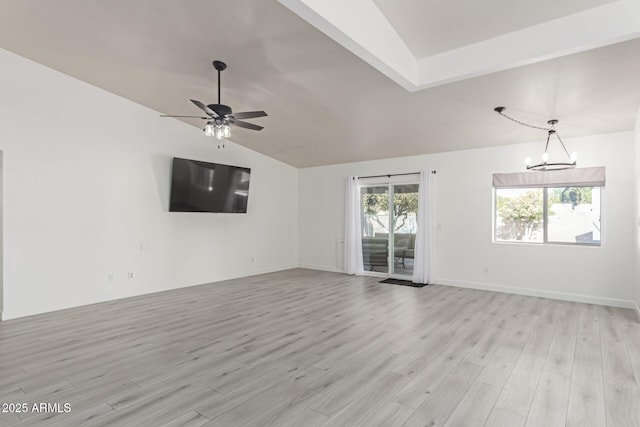 unfurnished living room with lofted ceiling, ceiling fan with notable chandelier, and light hardwood / wood-style flooring