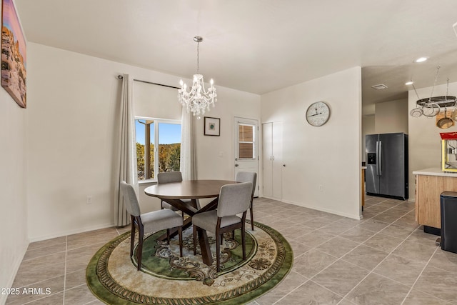 dining space with an inviting chandelier, light tile patterned floors, recessed lighting, and baseboards