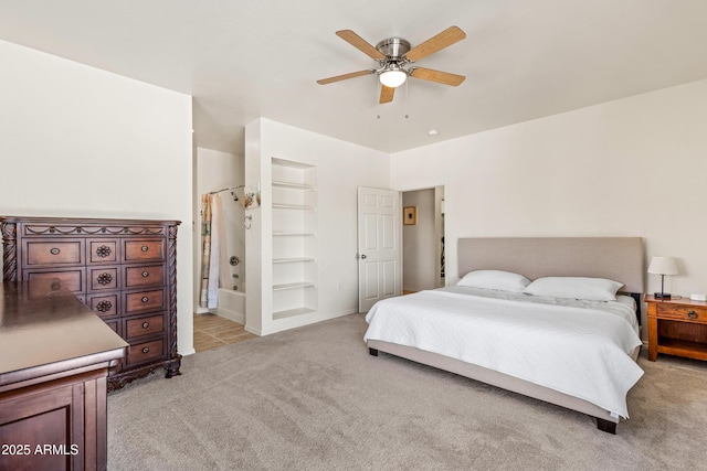 bedroom featuring a ceiling fan and light colored carpet