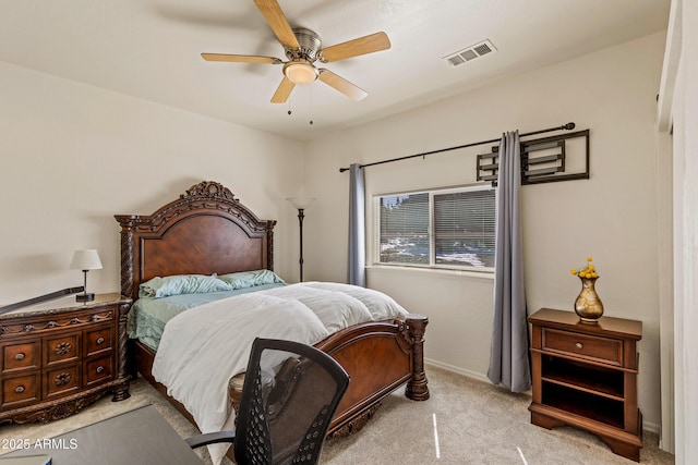 carpeted bedroom featuring visible vents, baseboards, and a ceiling fan