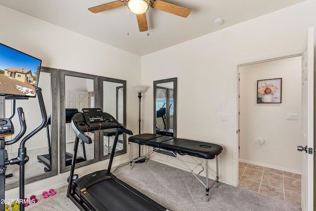 exercise area with tile patterned flooring, a ceiling fan, and baseboards