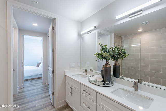 bathroom with hardwood / wood-style floors and vanity