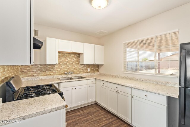 122 N 5th St, Avondale, AZ 85323 - kitchen with a sink, gas range oven, freestanding refrigerator, range hood, and white cabinets