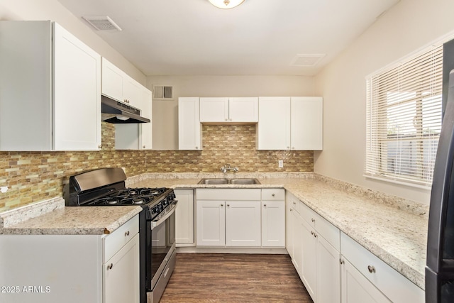122 N 5th St, Avondale, AZ 85323 - kitchen featuring stainless steel range with gas cooktop, under cabinet range hood, a sink, white cabinetry, and backsplash