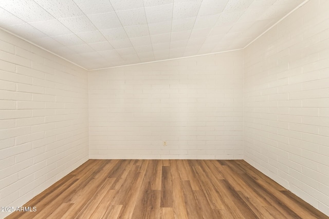 122 N 5th St, Avondale, AZ 85323 - spare room featuring wood finished floors and brick wall