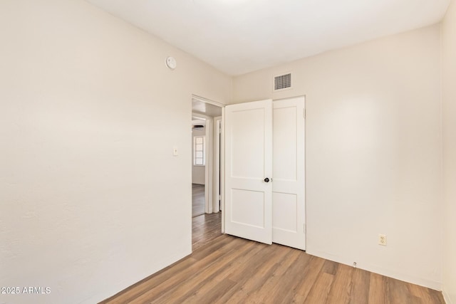 122 N 5th St, Avondale, AZ 85323 - unfurnished bedroom with wood finished floors and baseboards