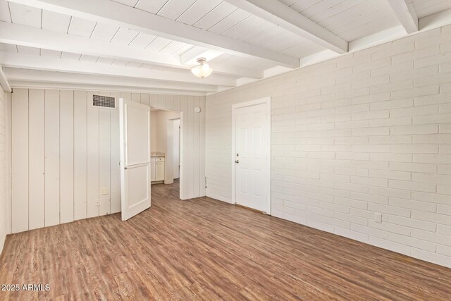 122 N 5th St, Avondale, AZ 85323 - spare room with wood finished floors, wood ceiling with exposed beams, wooden walls, and brick wall