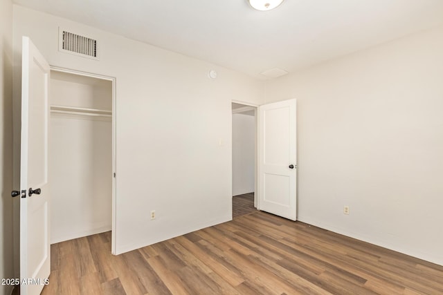 122 N 5th St, Avondale, AZ 85323 - unfurnished bedroom featuring wood finished floors and a closet
