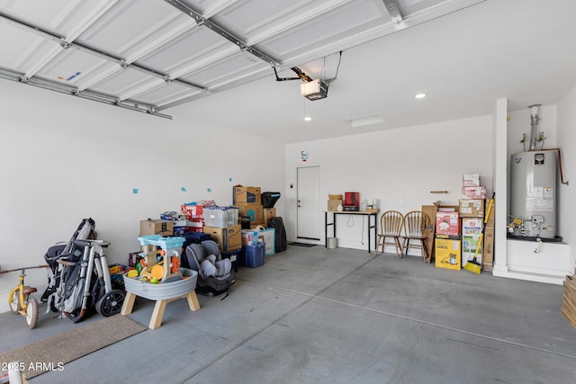 garage featuring recessed lighting, gas water heater, and a garage door opener