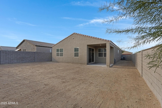 back of property featuring a patio, a fenced backyard, a tiled roof, and stucco siding