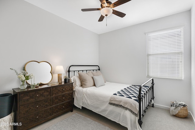 carpeted bedroom featuring baseboards and a ceiling fan