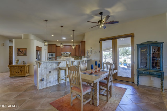 tiled dining area featuring ceiling fan