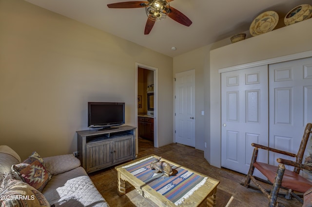 living room featuring dark carpet and ceiling fan