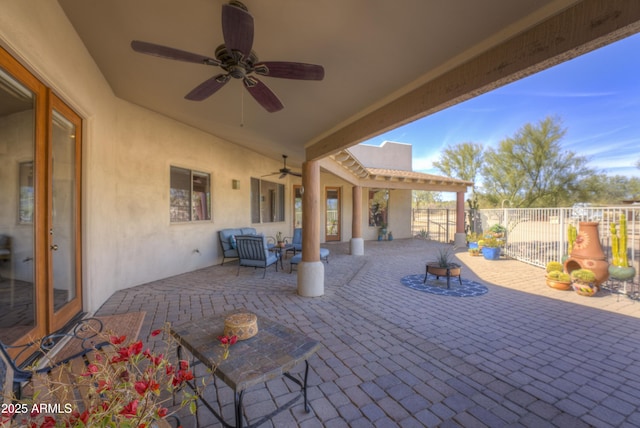 view of patio featuring ceiling fan