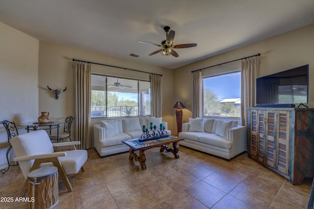 living room featuring a wealth of natural light and ceiling fan