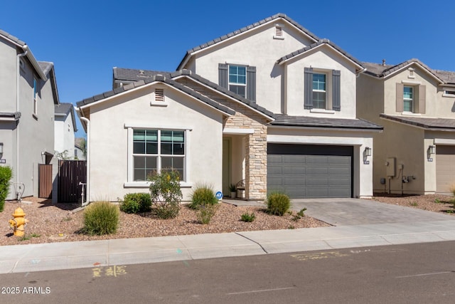 view of front of property featuring stucco siding, an attached garage, stone siding, driveway, and a tiled roof