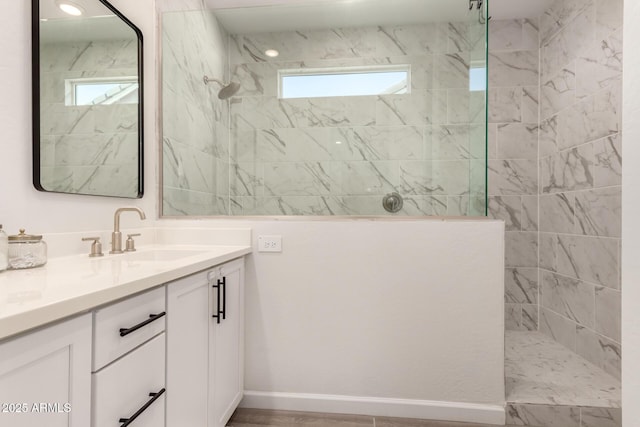 bathroom with walk in shower and vanity