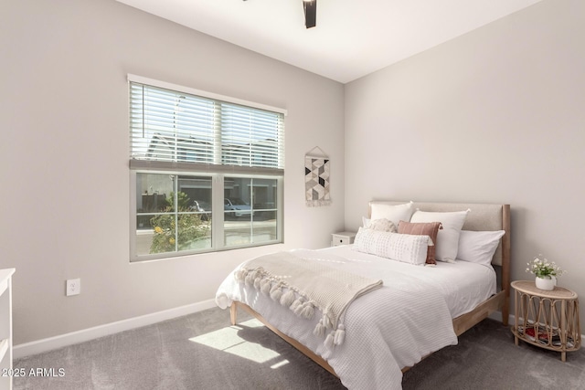 carpeted bedroom with ceiling fan and baseboards