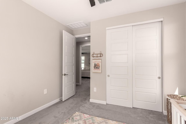 unfurnished bedroom with a closet, light carpet, visible vents, and baseboards