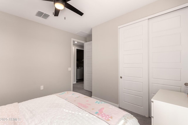 carpeted bedroom with a closet, visible vents, washer / clothes dryer, a ceiling fan, and baseboards