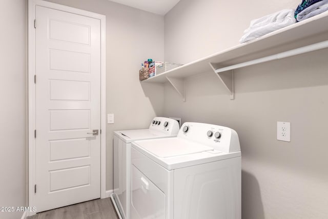 laundry area with laundry area, light wood-style flooring, and washer and dryer