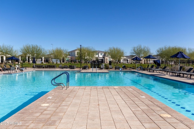 community pool featuring a patio and fence