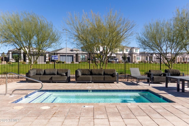 view of swimming pool with a patio area, fence, and outdoor lounge area