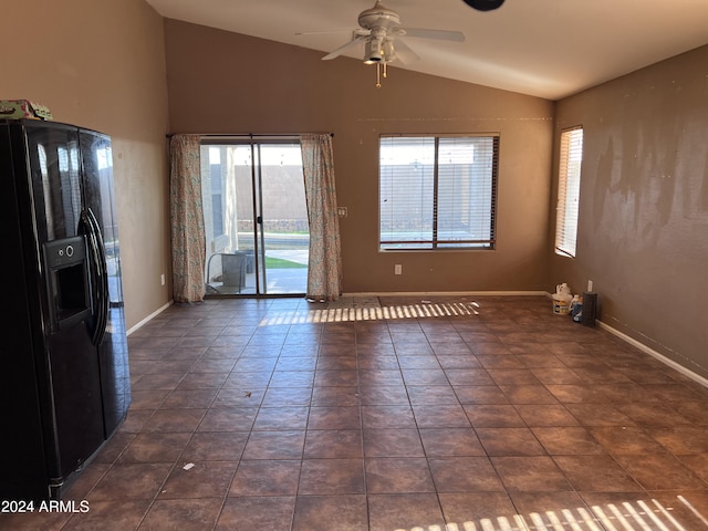 tiled spare room featuring vaulted ceiling and ceiling fan