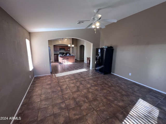 unfurnished living room with ceiling fan and lofted ceiling