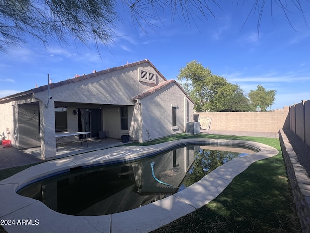 view of pool featuring cooling unit and a patio area