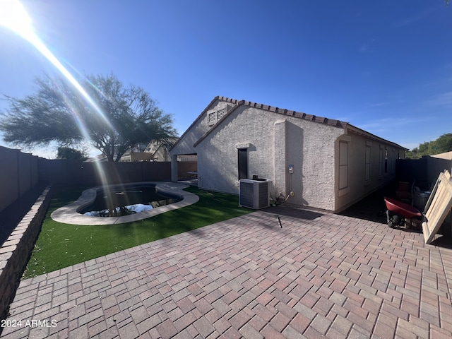 view of patio / terrace featuring a fenced in pool and central air condition unit