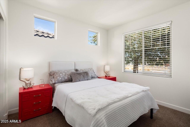 carpeted bedroom featuring multiple windows