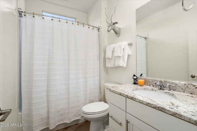 full bathroom featuring vanity, hardwood / wood-style floors, shower / bath combination with curtain, and toilet