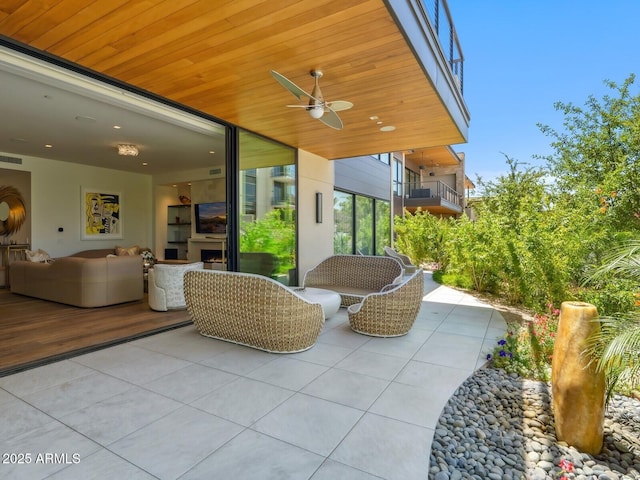 view of patio featuring ceiling fan and an outdoor living space