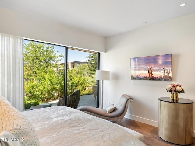 bedroom featuring wood finished floors and baseboards