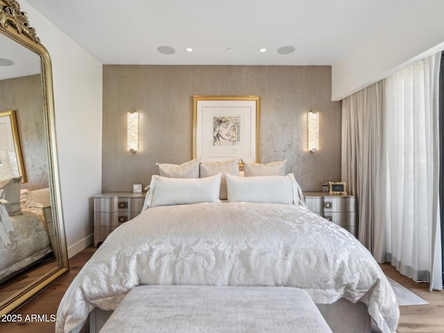 bedroom featuring wood finished floors and baseboards