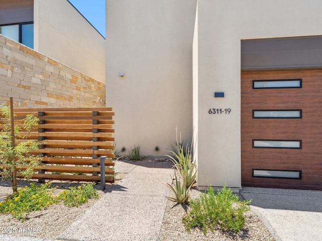 view of exterior entry featuring stucco siding